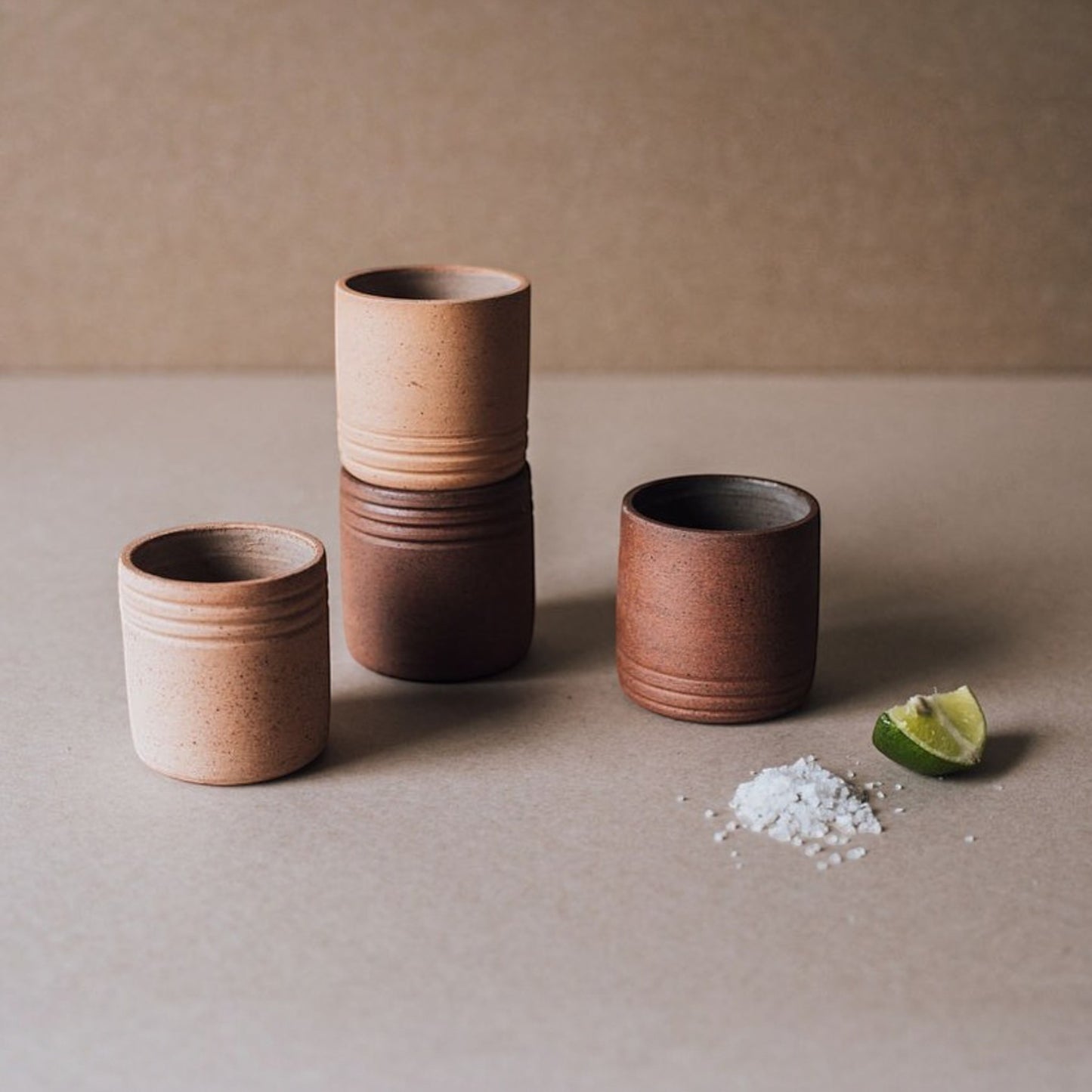 Set of small-batch ceramic mezcal shot cups arranged in clean minimal style