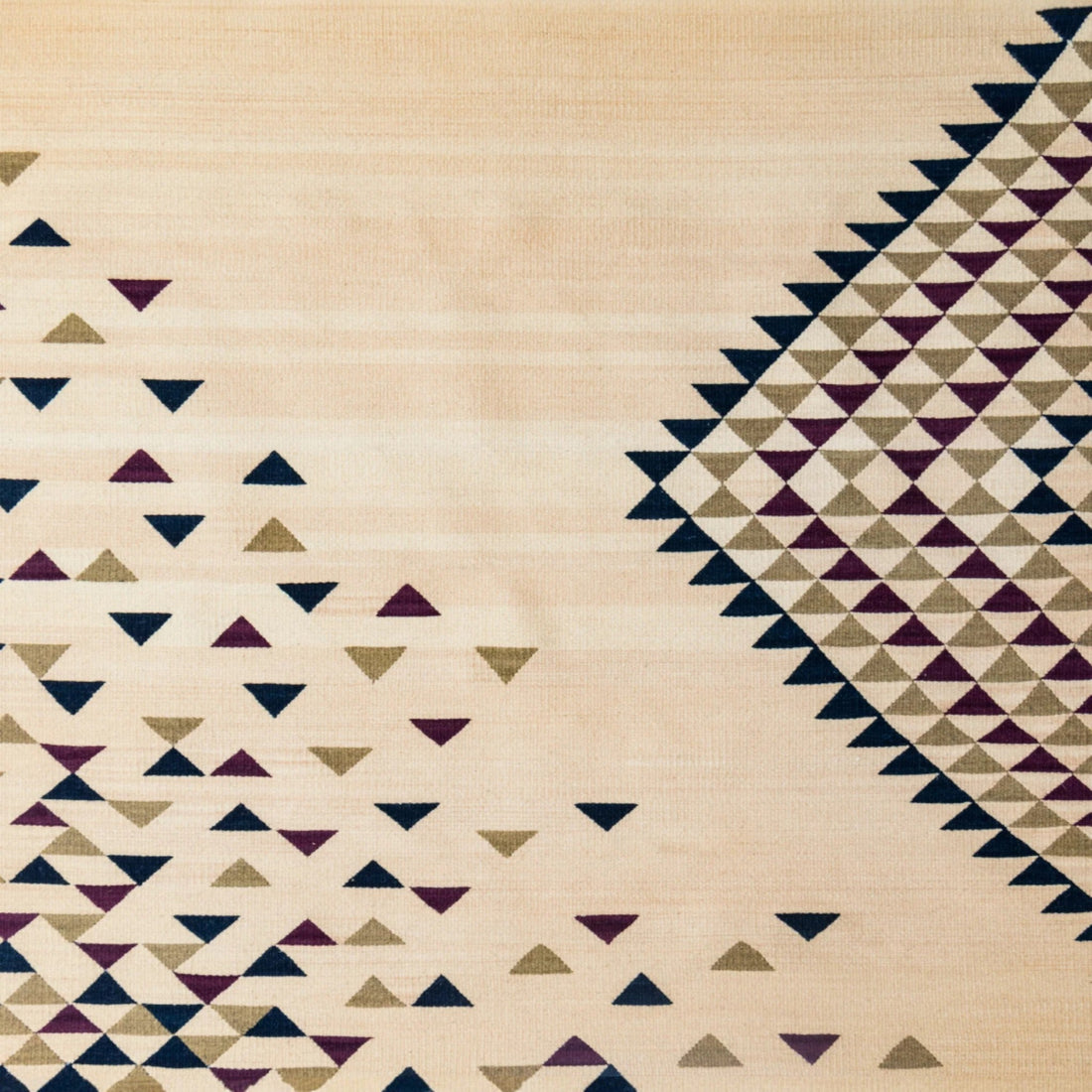 Detail of a handwoven Zapotec textile from Oaxaca featuring traditional geometric motifs in natural tones