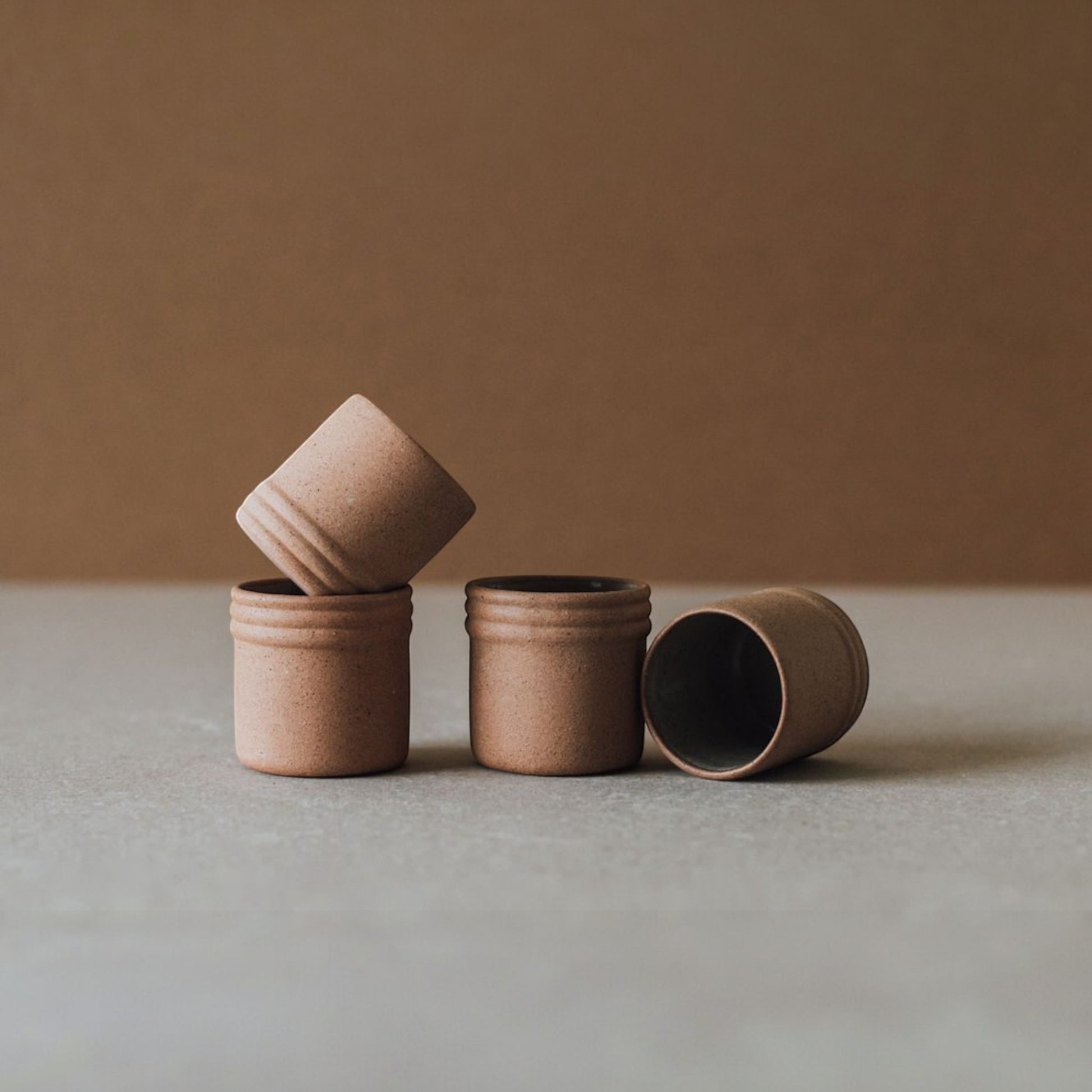 Tequila shot glass set displayed on tabletop with warm clay tones