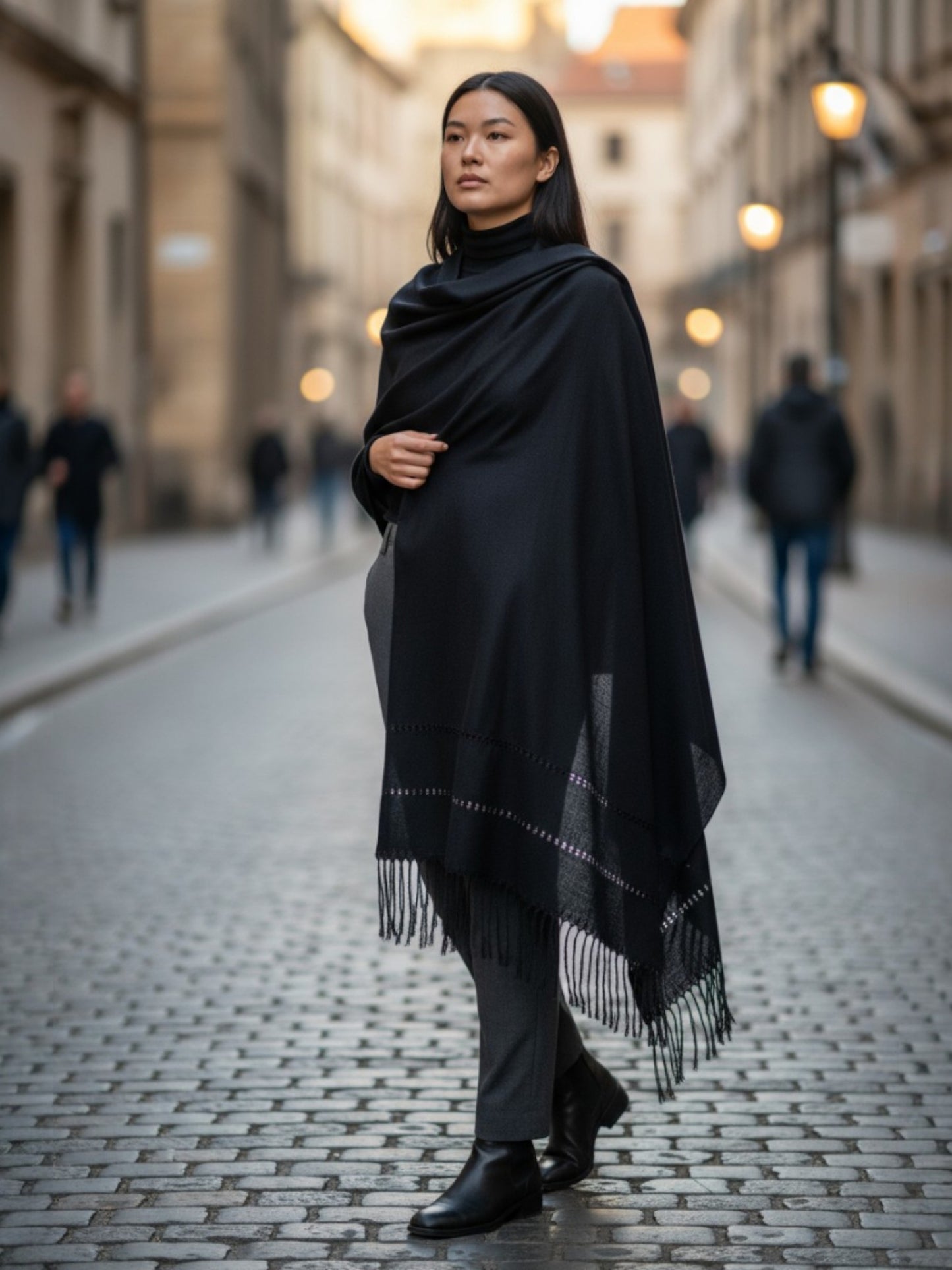 Woman wearing a black handwoven silk-blend rebozo shawl on a city street