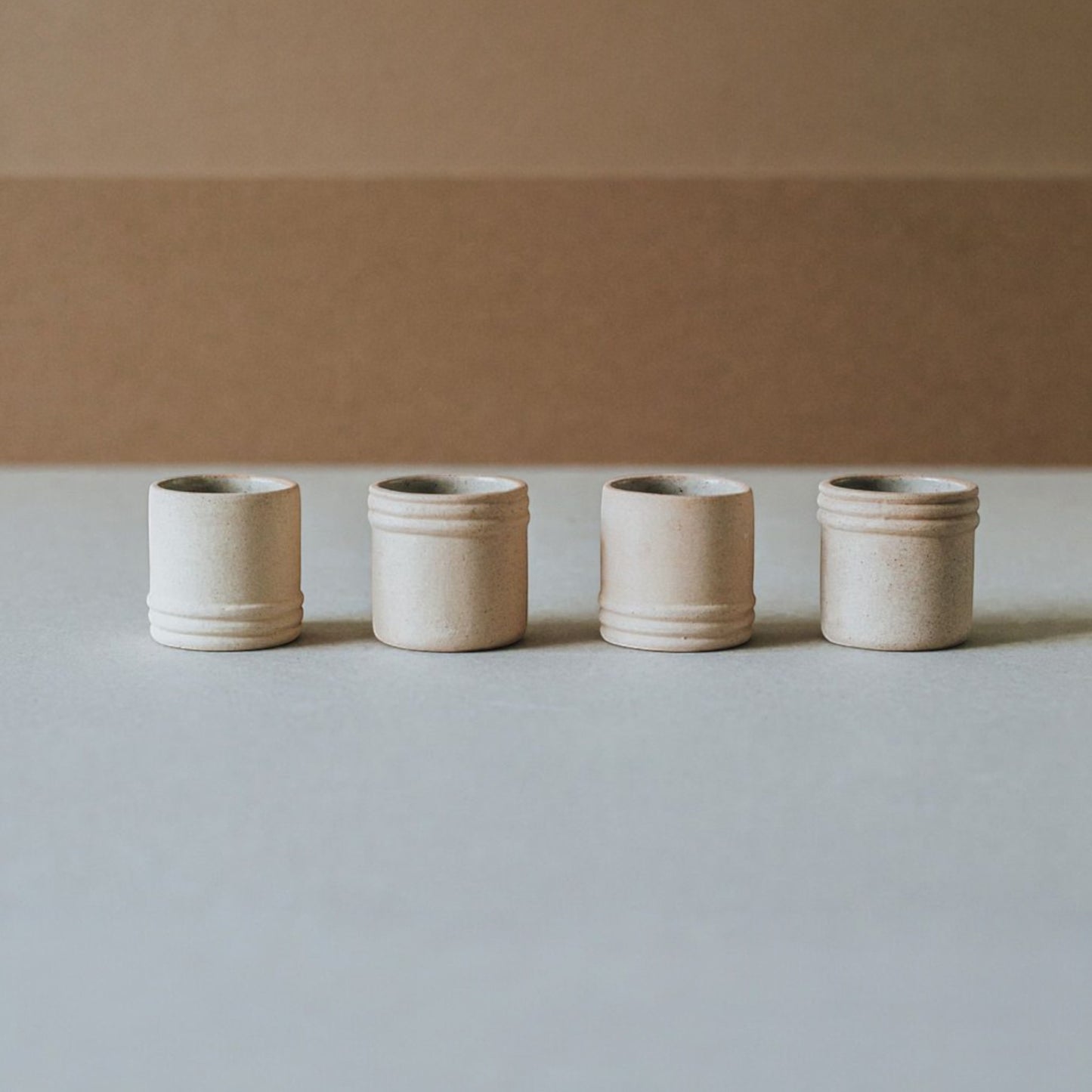 Artisan mezcal shot cup held in hand to show scale and matte finish