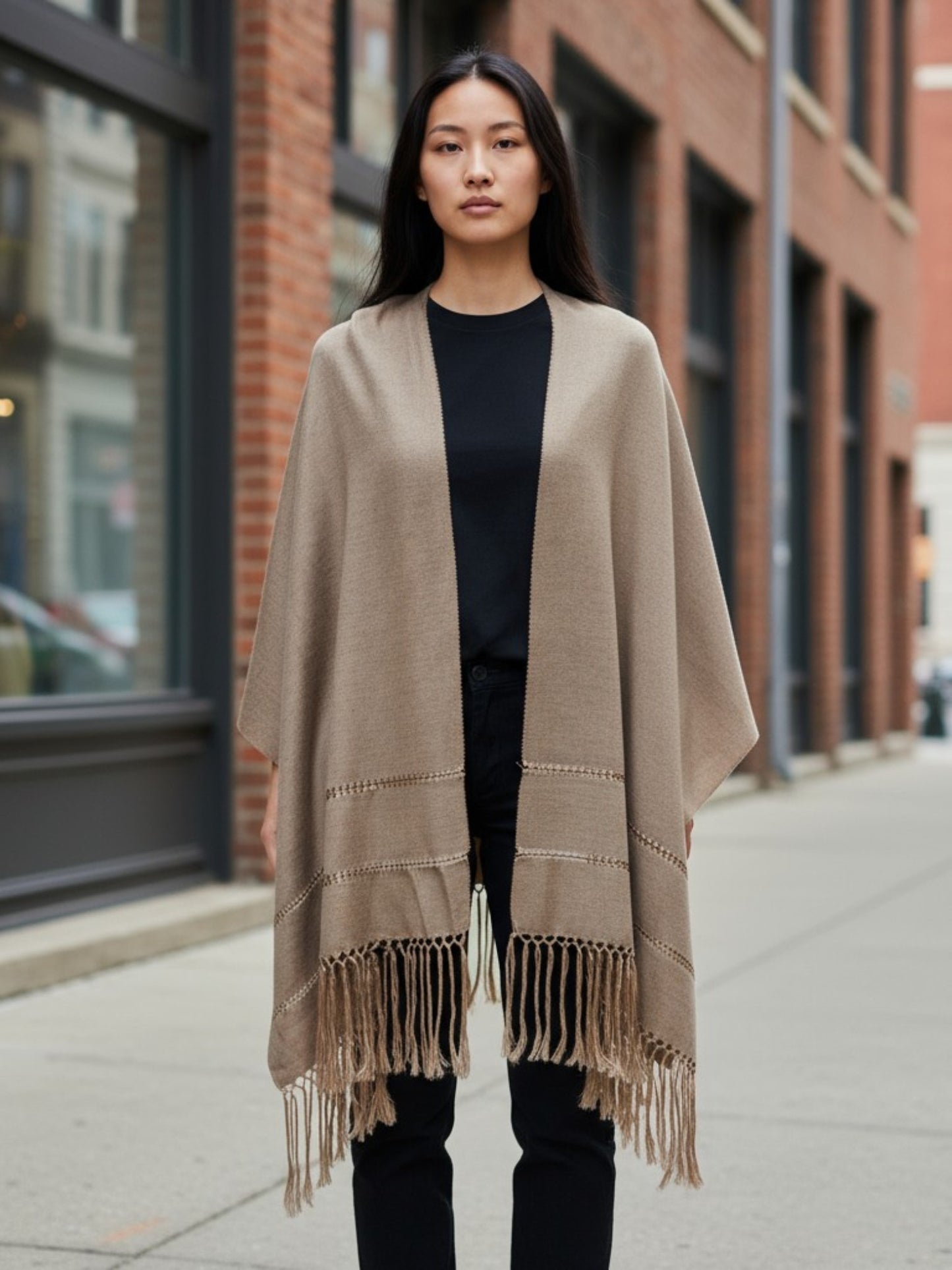 Woman wearing a taupe handwoven silk-blend rebozo shawl on a city sidewalk