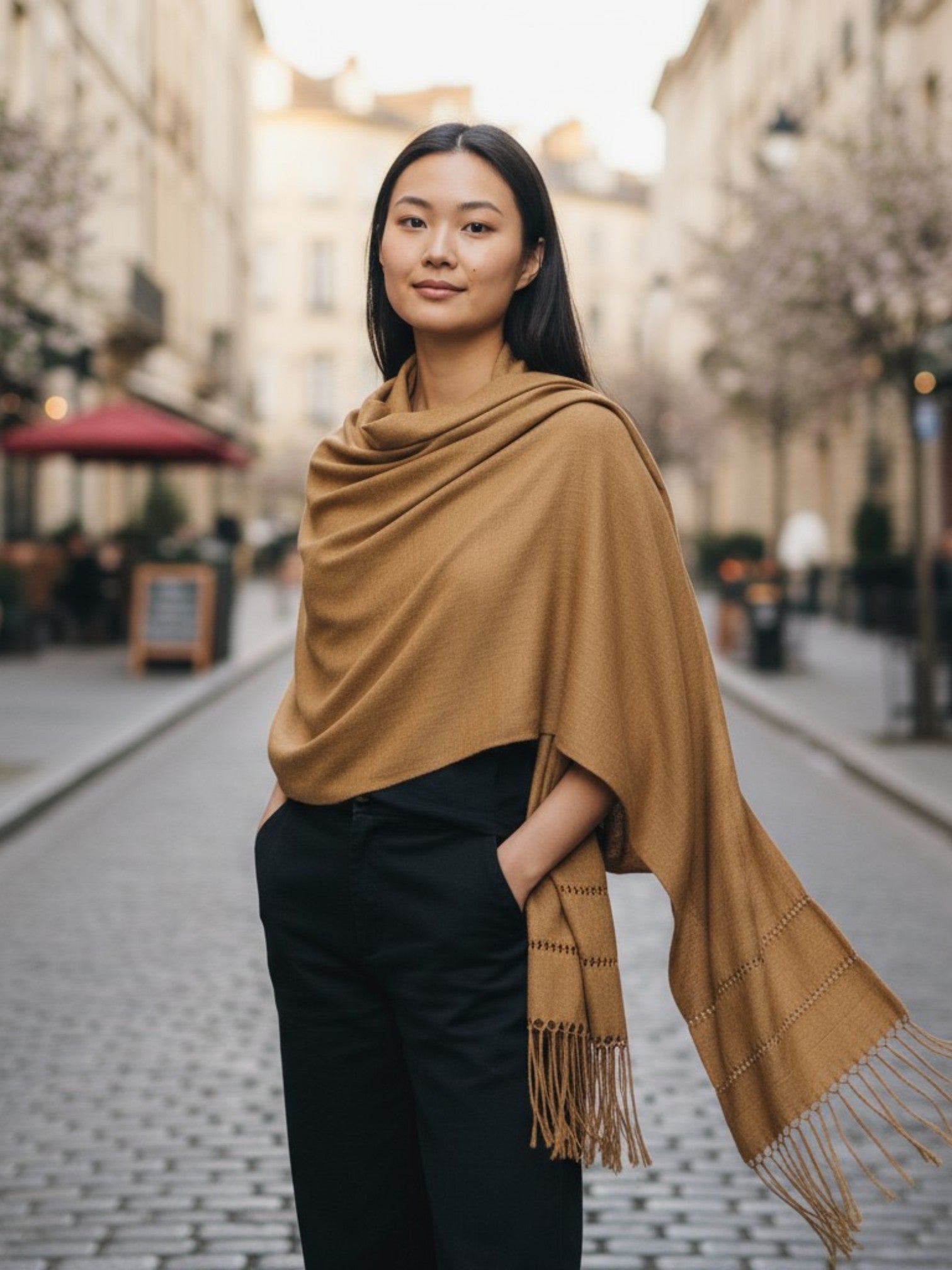 Gold-colored silk-blend rebozo shawl styled casually outdoors
