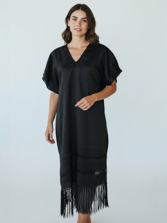 Handwoven silk blend kaftan dress in black with V-neck and fringe hem, front view on neutral studio background