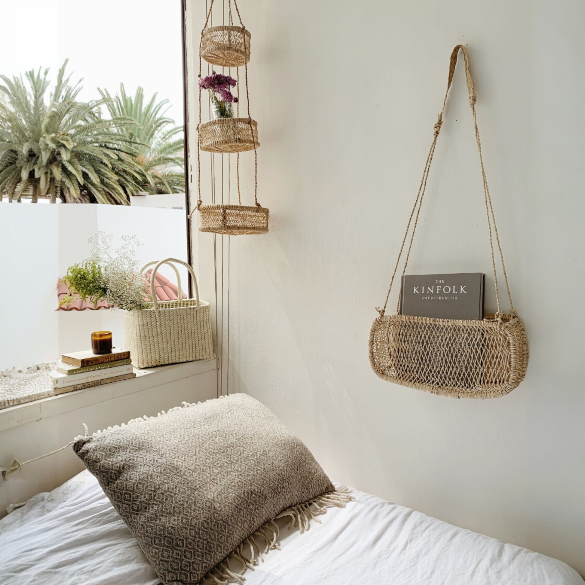 Three-tier jonote hanging basket displayed in a bedroom next to a window.