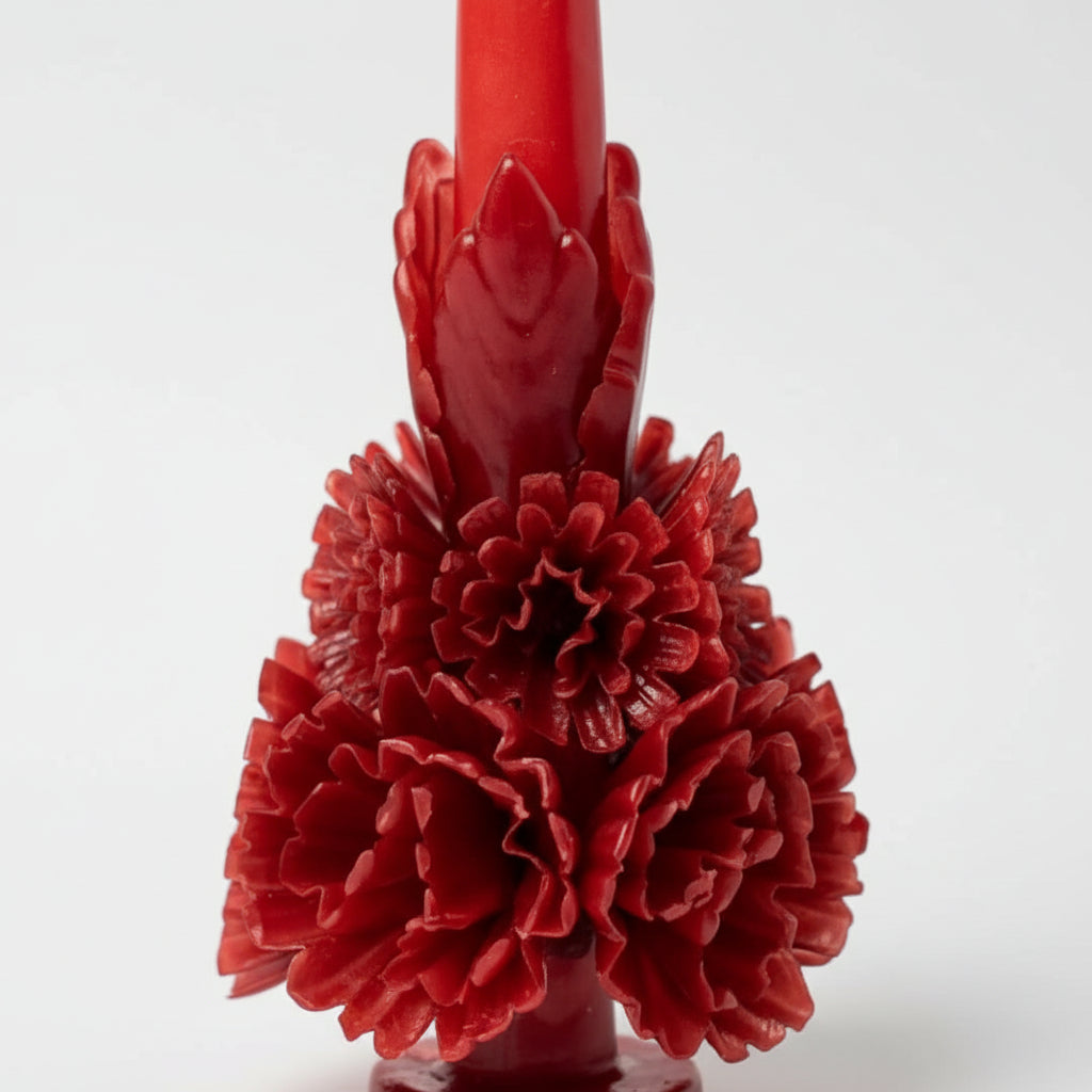 Close-up of red carved beeswax floral candle details