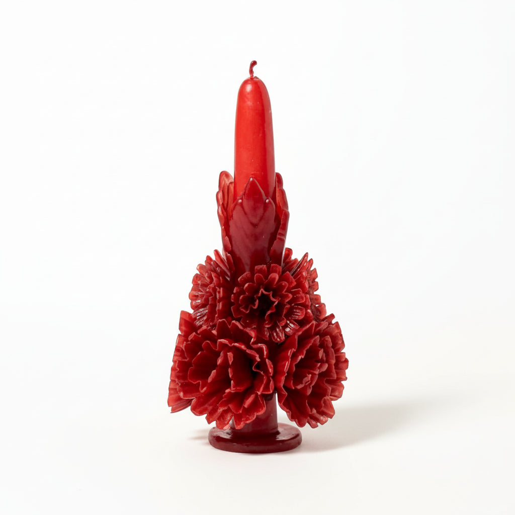 Red carved beeswax floral candle on a white background