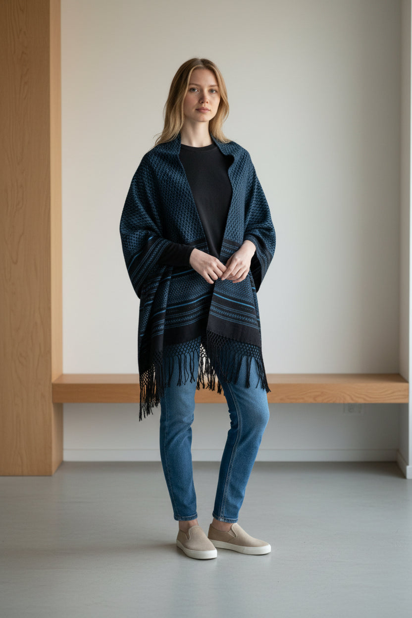 Handwoven cotton rebozo shawl in dark blue with subtle diamond weave, styled casually with denim