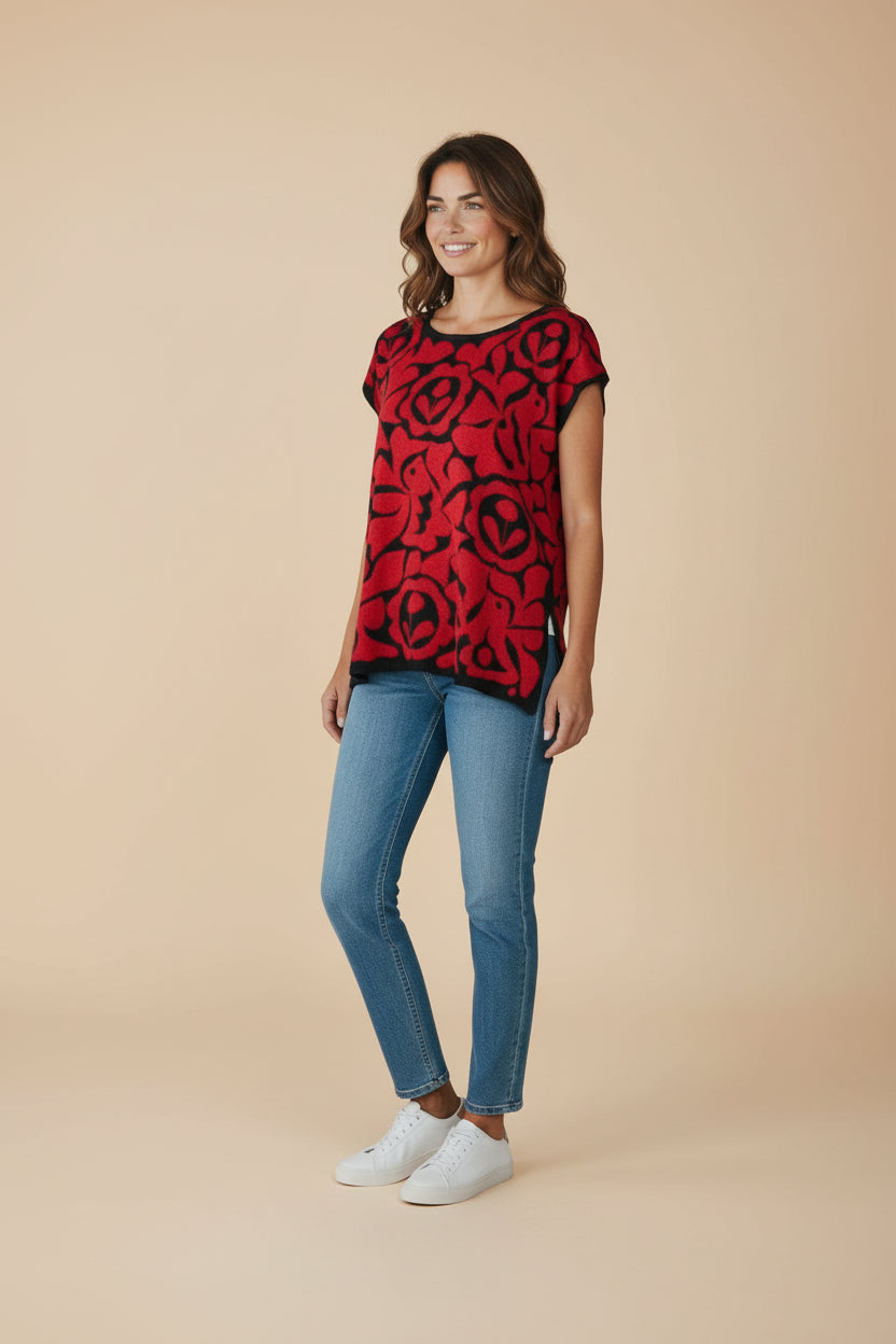 Huipil-inspired Oaxacan Istmo floral blouse with contrasting black trim, lightweight cotton-blend knit top on model