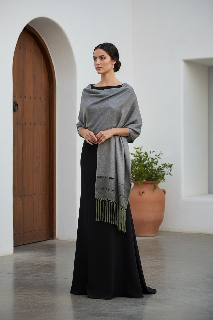 Silver artisan rebozo shawl draped over a black formal dress – handwoven Mexican wrap for weddings and special occasions.
