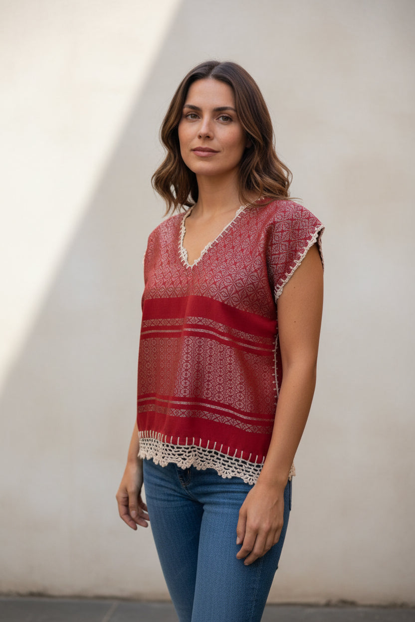 Oaxaca handwoven cotton huipil top in coral red worn by model, three-quarter side view against neutral background